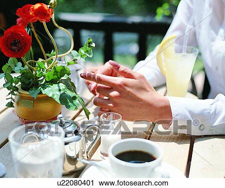 Stock Image - indoors, woman, fingers, eating, food, body part. Fotosearch