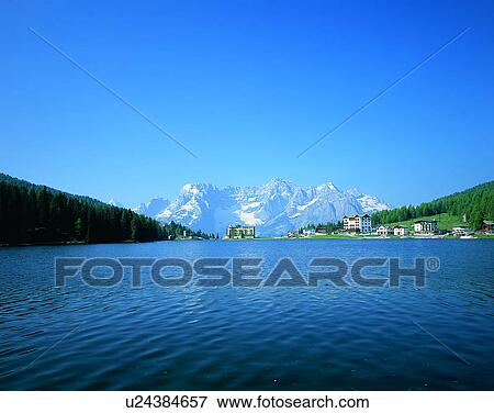 Stock Photo - lakeside, water, nature, sky, mountains, landscape. Fotosearch