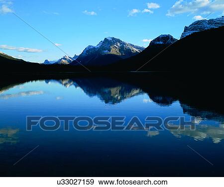 Stock Photo - lakeside, water, nature, sky, mountains, landscape. Fotosearch