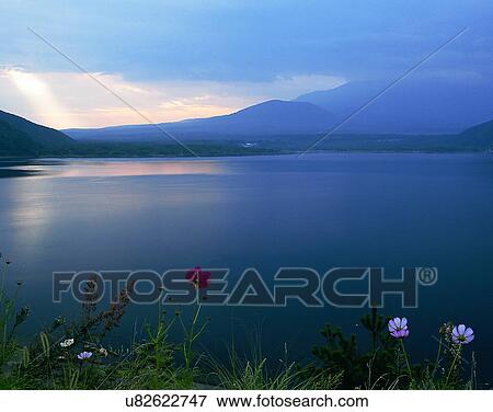 Stock Photo - lakeside, water, nature, sky, mountains, landscape. Fotosearch