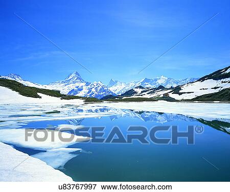 Stock Photo - lakeside, water, nature, sky, mountains, landscape. Fotosearch