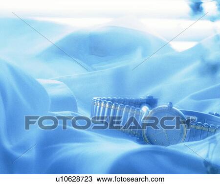 Stock Image - lifestyle, close-up, blue, watch, sheets. Fotosearch
