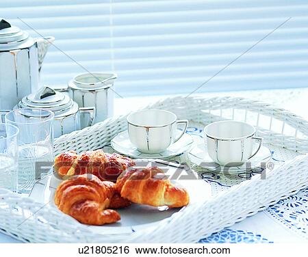 Stock Photograph - lifestyle, close-up, breakfast, tea cups, saucers, croissants. Fotosearch