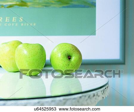 Stock Image - lifestyle, close-up, indoor, fruits, green apples, reflection. Fotosearch