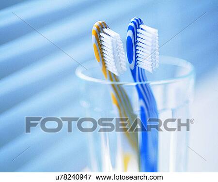 Stock Photo - lifestyle, close-up, indoor, toothbrushes, glass, water. Fotosearch