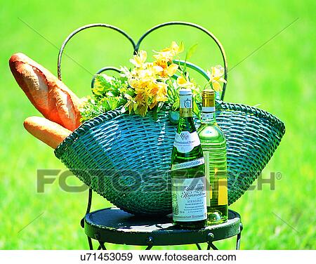 Stock Photo - lifestyle, outdoor, grass, breads, flowers, basket. Fotosearch