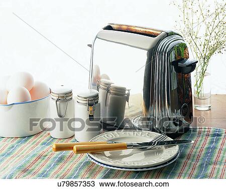 Stock Image - lifestyle, toaster, plates, silverware, tablecloth, eggs. Fotosearch