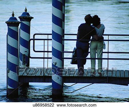 Stock Image - love, couples, companionship, outdoors, dusk, standing. Fotosearch