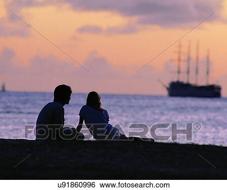 Stock Photograph - love, couples, companionship, outdoors, beach, dusk. Fotosearch