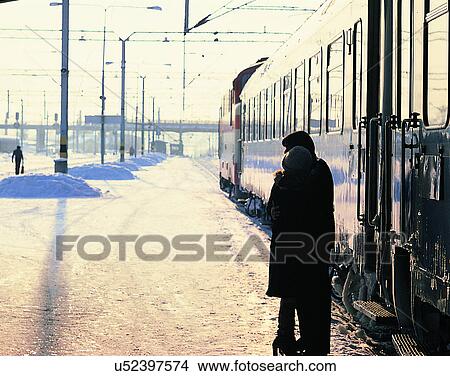 Picture - love, couples, goodbye, train station, winter, standing. Fotosearch