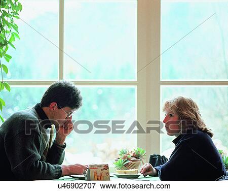Stock Photo - love, couples, indoors, windows, young. Fotosearch