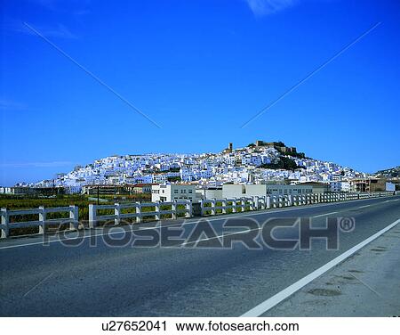 Stock Image - road, outdoor, hill, sky, light, houses. Fotosearch