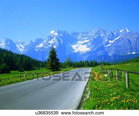 road, outdoor, mountains, sky, light, grass View Large Photo Image Stock Photo - road, outdoor, mountains, sky, light, grass. Fotosearch