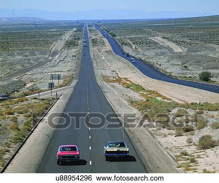 Stock Photograph - road, outdoor, sky, light, cars, bushes. Fotosearch