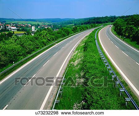 Stock Photo - road, outdoor, sky, light, grass, clouds. Fotosearch