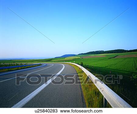 Stock Image - road, outdoor, trees, sky, grass, clouds. Fotosearch