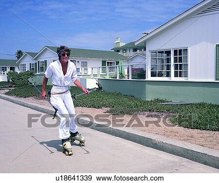Stock Photo - sport, outdoors, residential, suburbs, person, rollerskating. Fotosearch