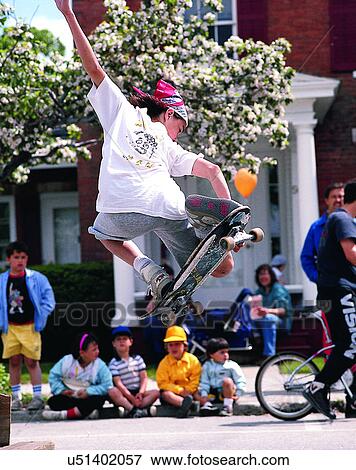 Stock Photo - sport, outdoors, skateboarding, person, jumping, crowd. Fotosearch