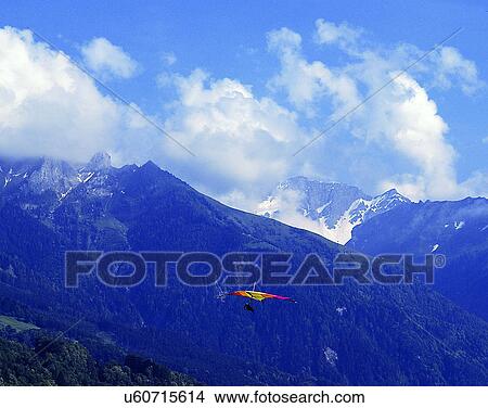 Picture - sport, outdoors, sky, gliding, person, mountains. Fotosearch