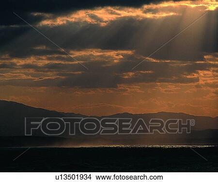Picture - sun light, sun, sky, clouds, outdoors, sunset. Fotosearch