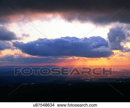 Picture - sun light, sun, sky, clouds, outdoors, sunset. Fotosearch