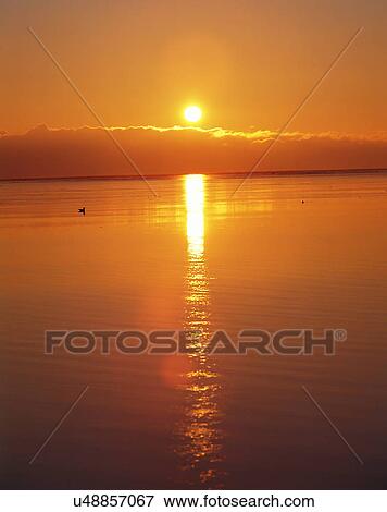 Stock Photo - sun light, sun, sky, clouds, outdoors, sunset. Fotosearch