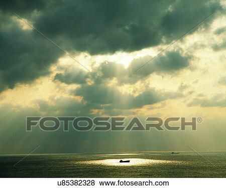 Stock Photo - sun light, sun, sky, clouds, outdoors, rays. Fotosearch
