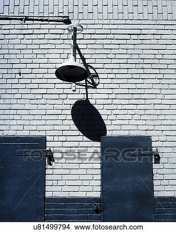 Picture - wall, close-up, brick, white, doors, lamp. Fotosearch