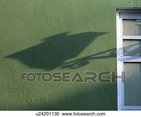 Stock Image - wall, close-up, window, shadow, lamp, green. Fotosearch