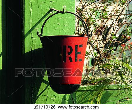 Stock Photograph - water bucket, outdoor, plants, shadow, artificial. Fotosearch