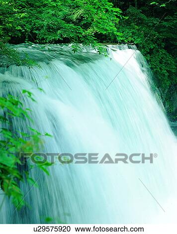 Stock Image - waterfall, nature, outdoors, rocks, trees, sunlight. Fotosearch