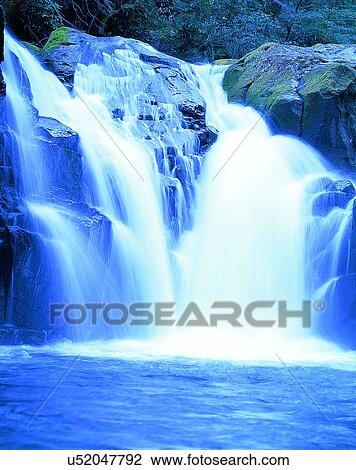 Stock Image - waterfall, nature, outdoors, rocks, plants, sunlight. Fotosearch