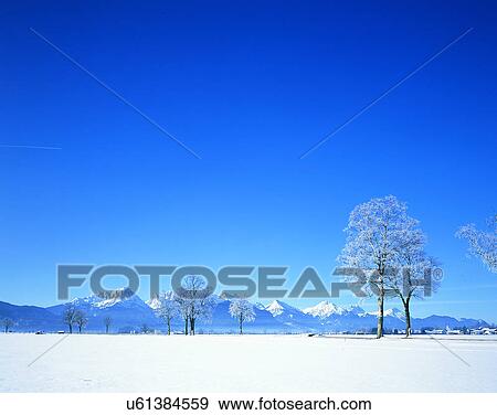 Stock Photo - winter, snow, outdoors, sky, buildings, mountains. Fotosearch