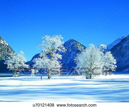 Stock Photo - winter, snow, outdoors, sky, buildings, mountains. Fotosearch