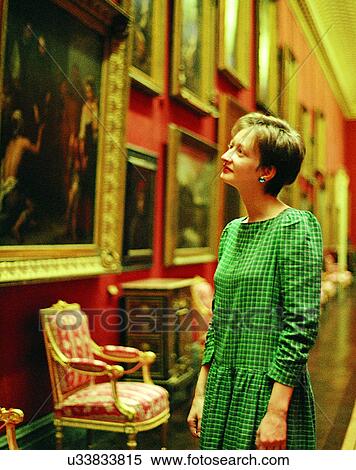 Stock Photography - woman, museum, painting, looking, chairs, antiques. Fotosearch