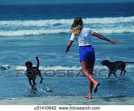 Stock Image - woman, outdoors, back, beach, water, waves. Fotosearch