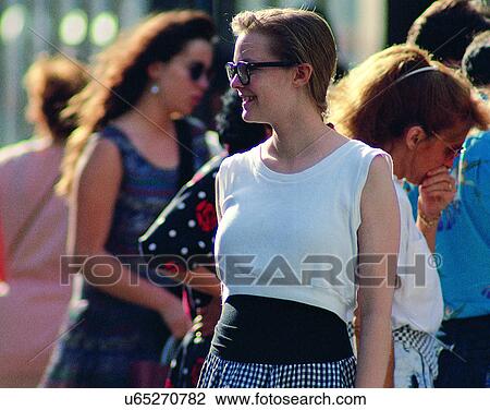 Stock Image - woman, outdoors, crowd, glasses, standing, city. Fotosearch