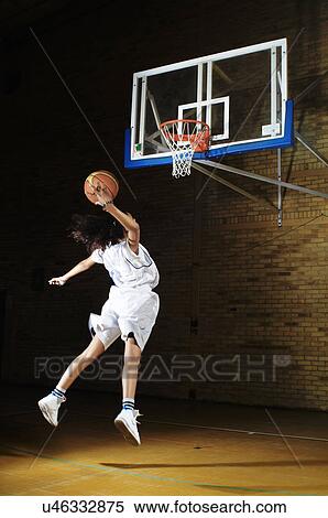 Stock Photography - Basketball player aiming at hoop. Fotosearch