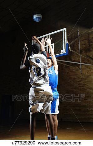 Basketball players playing on court View Large Photo Image Stock Image - Basketball players playing on court. Fotosearch