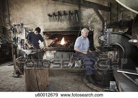 Blacksmiths at work View Large Photo Image Stock Photo - Blacksmiths at work. Fotosearch