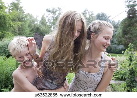 Boy and teenage girls play fighting in garden View Large Photo Image Stock Photography - Boy and teenage girls play fighting in garden. Fotosearch