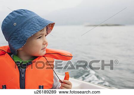 Stock Photo - Boy enjoying boat ride. Fotosearch