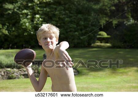 Boy in garden throwing rugby ball View Large Photo Image Stock Image - Boy in garden throwing rugby ball. Fotosearch