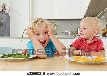 Boy playing with asparagus View Large Photo Image Stock Photography - Boy playing with asparagus. Fotosearch
