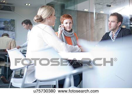 Businesspeople having meeting at conference table View Large Photo Image Stock Image - Businesspeople having meeting at conference table. Fotosearch