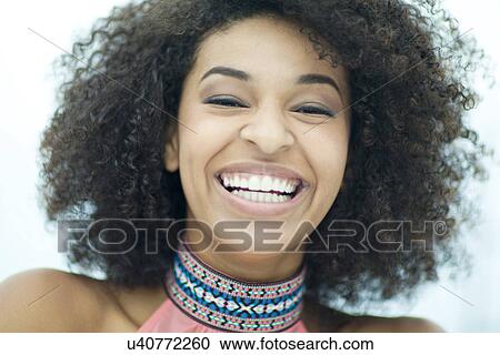 Stock Image - Close up portrait of smiling young woman. Fotosearch
