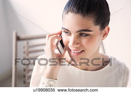 Stock Photography - Close up portrait of young woman on mobile. Fotosearch