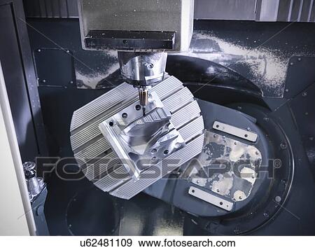 Stock Photo - Complex steel part on computer numerical controlled, CNC, lathe in factory. Fotosearch