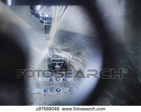 Stock Photo - Computer numerical controlled (CNC) lathe in factory, close up. Fotosearch