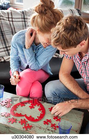 Couple doing heart shaped jigsaw View Large Photo Image Stock Image - Couple doing heart shaped jigsaw. Fotosearch